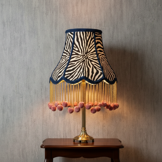 Zebra print lampshade with pink pom poms on Cuba Plain grey textured wallpaper