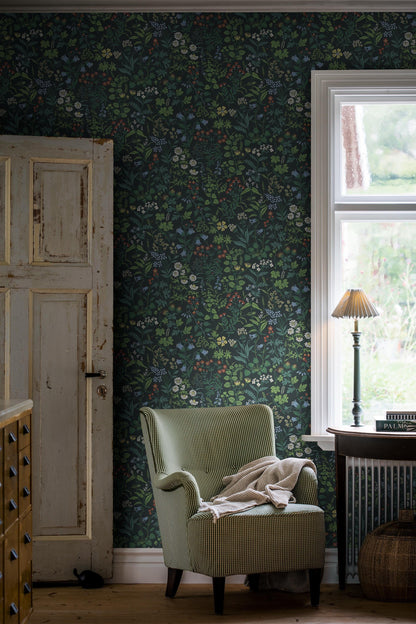Flora wallpaper in Midnight Blue on a living room wall
