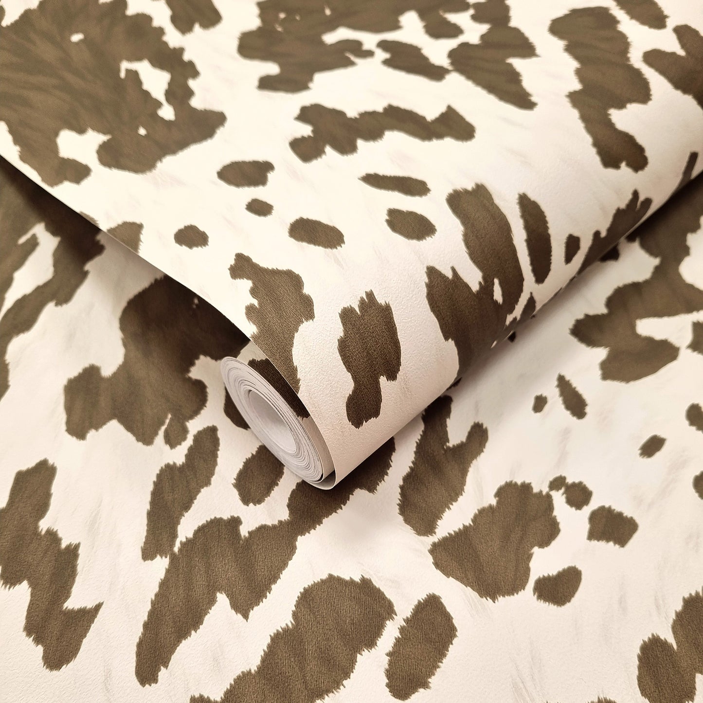 Holstein Cocoa wallpaper roll showing the cowhide-pattern repeat