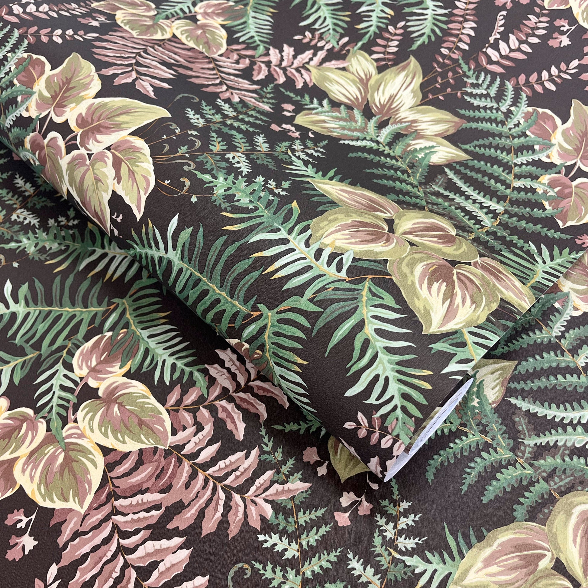 Rowan Charcoal wallpaper roll showing the hand-painted leaf repeat