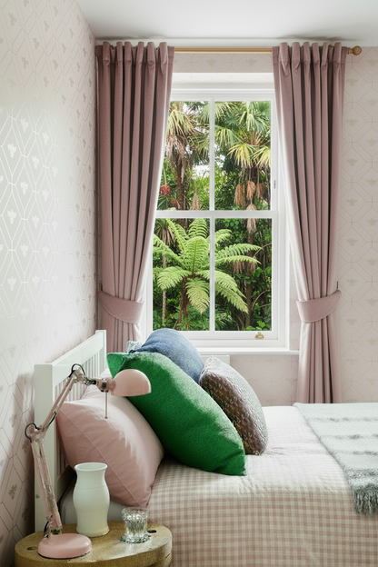 Bedroom with NZ bush view through window and pink pillowcases